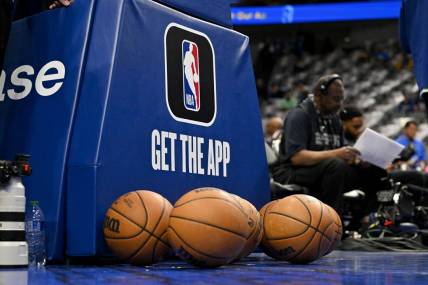 Mar 5, 2023; Dallas, Texas, USA; A view of the NBA logo and NBA app logo and basketballs in front of the base during warms up before the game between the Dallas Mavericks and the Suns at the American Airlines Center. Mandatory Credit: Jerome Miron-USA TODAY Sports
