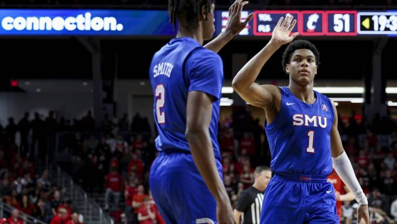 Mar 5, 2023; Cincinnati, Ohio, USA;  Southern Methodist Mustangs guard Zhuric Phelps (1) high-fives guard Jalen Smith (2) during a stop in play against the Cincinnati Bearcats in the second half at Fifth Third Arena. Mandatory Credit: Aaron Doster-USA TODAY Sports