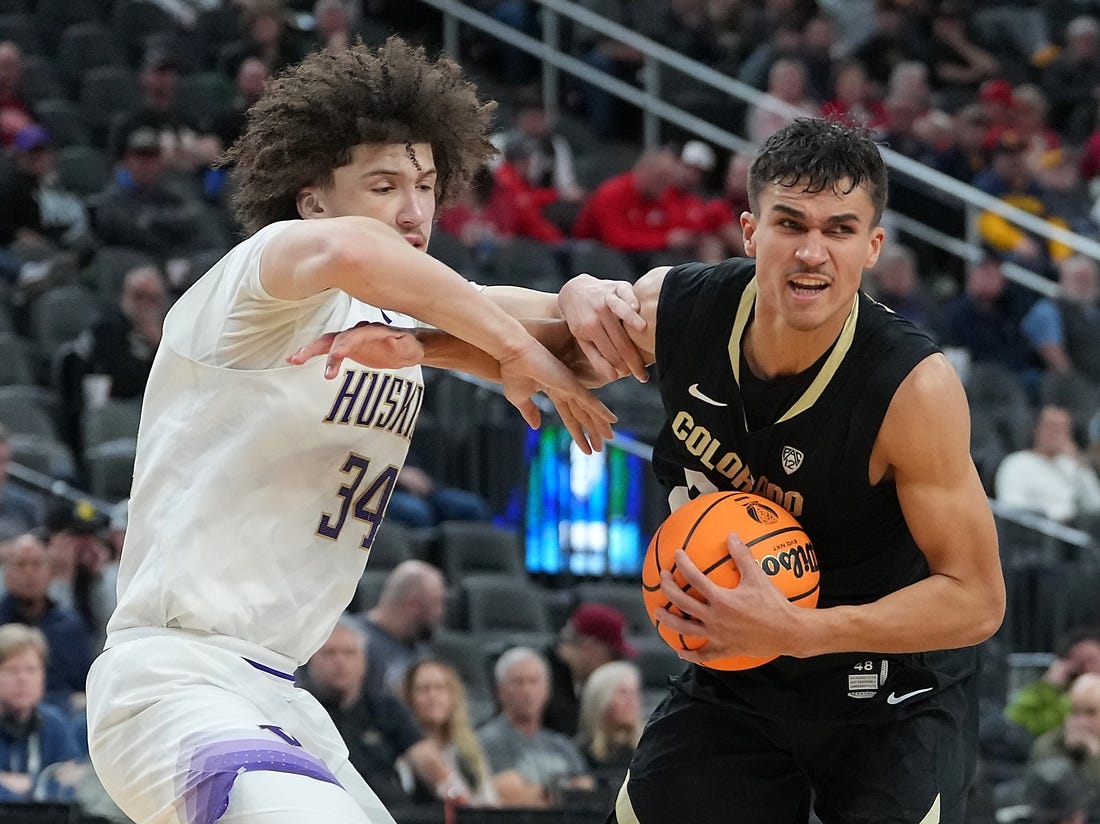 Mar 8, 2023; Las Vegas, NV, USA; Colorado Buffaloes forward Tristan da Silva (23) protects the ball from Washington Huskies center Braxton Meah (34) during the second half at T-Mobile Arena. Mandatory Credit: Stephen R. Sylvanie-USA TODAY Sports