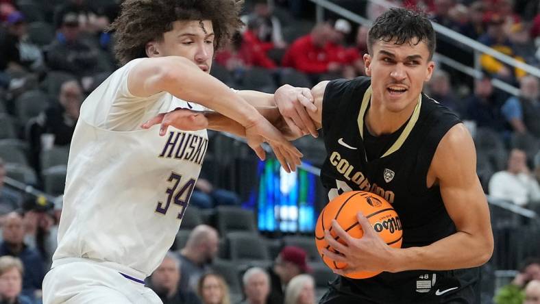 Mar 8, 2023; Las Vegas, NV, USA; Colorado Buffaloes forward Tristan da Silva (23) protects the ball from Washington Huskies center Braxton Meah (34) during the second half at T-Mobile Arena. Mandatory Credit: Stephen R. Sylvanie-USA TODAY Sports