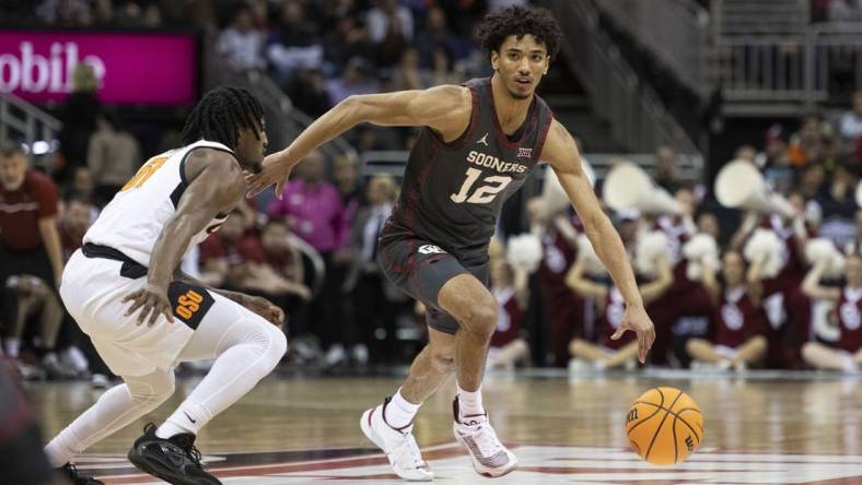 Mar 8, 2023; Kansas City, MO, USA; Oklahoma Sooners guard Milos Uzan (12) dribbles the ball while defended by Oklahoma State Cowboys guard John-Michael Wright (51) in the first half at T-Mobile Center. Mandatory Credit: Amy Kontras-USA TODAY Sports