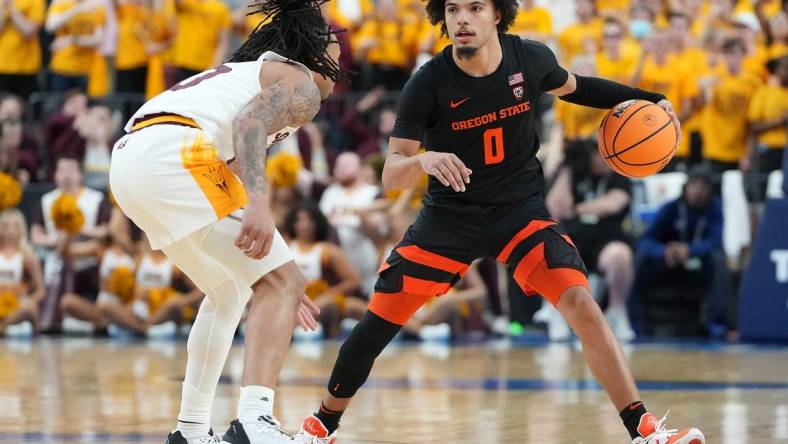 Mar 8, 2023; Las Vegas, NV, USA; Oregon State Beavers guard Jordan Pope (0) dribbles against Arizona State Sun Devils guard Frankie Collins (10) during the second half at T-Mobile Arena. Mandatory Credit: Stephen R. Sylvanie-USA TODAY Sports