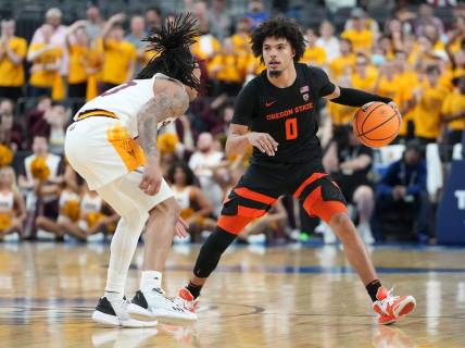Mar 8, 2023; Las Vegas, NV, USA; Oregon State Beavers guard Jordan Pope (0) dribbles against Arizona State Sun Devils guard Frankie Collins (10) during the second half at T-Mobile Arena. Mandatory Credit: Stephen R. Sylvanie-USA TODAY Sports