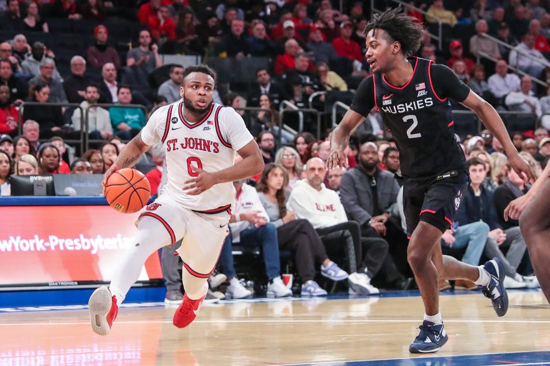 Feb 25, 2023; New York, New York, USA;  St. John's Red Storm guard Posh Alexander (0) and Connecticut Huskies guard Tristen Newton (2) at Madison Square Garden. Mandatory Credit: Wendell Cruz-USA TODAY Sports