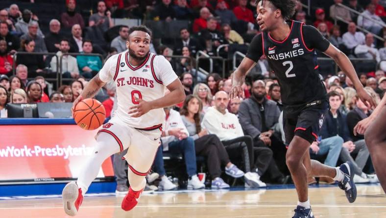 Feb 25, 2023; New York, New York, USA;  St. John's Red Storm guard Posh Alexander (0) and Connecticut Huskies guard Tristen Newton (2) at Madison Square Garden. Mandatory Credit: Wendell Cruz-USA TODAY Sports