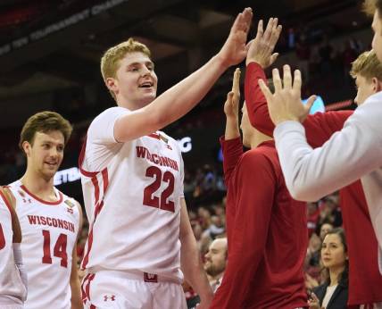 Wisconsin forward Steven Crowl (22) is congratulated by teammates during the second half of their opening round game of the National Invitation Tournament Tuesday, March 14, 2023 at the Kohl Center in Madison, Wis. Crowl scored a career high 36 points. Wisconsin beat Bradley 81-62.

Uwmen14 13