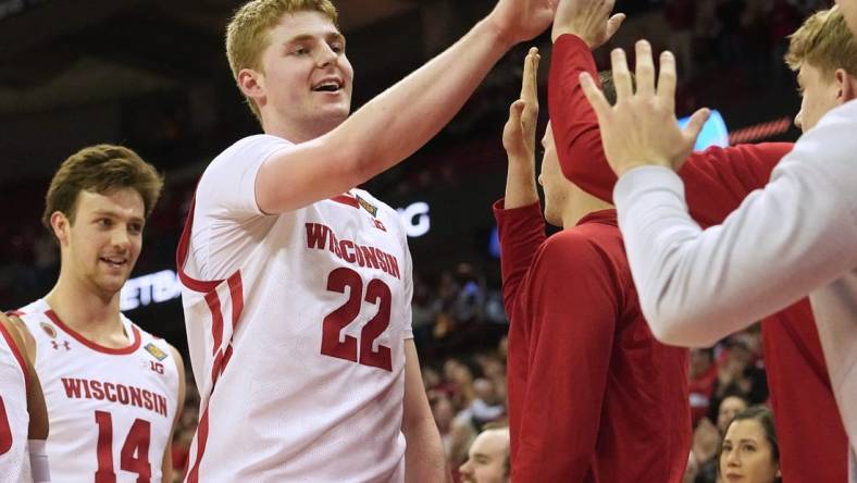 Wisconsin forward Steven Crowl (22) is congratulated by teammates during the second half of their opening round game of the National Invitation Tournament Tuesday, March 14, 2023 at the Kohl Center in Madison, Wis. Crowl scored a career high 36 points. Wisconsin beat Bradley 81-62.

Uwmen14 13