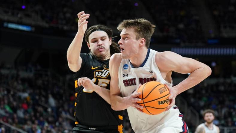 Mar 17, 2023; Albany, NY, USA; St. Mary's Gaels center Mitchell Saxen (11) dribbles the ball against Virginia Commonwealth Rams forward David Shriver (35) during the first half at MVP Arena. Mandatory Credit: David Butler II-USA TODAY Sports