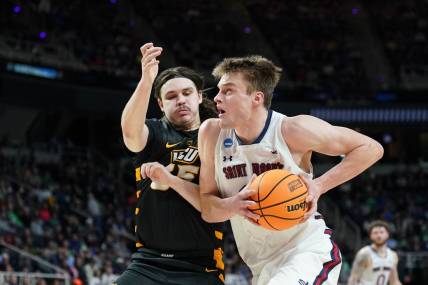 Mar 17, 2023; Albany, NY, USA; St. Mary's Gaels center Mitchell Saxen (11) dribbles the ball against Virginia Commonwealth Rams forward David Shriver (35) during the first half at MVP Arena. Mandatory Credit: David Butler II-USA TODAY Sports