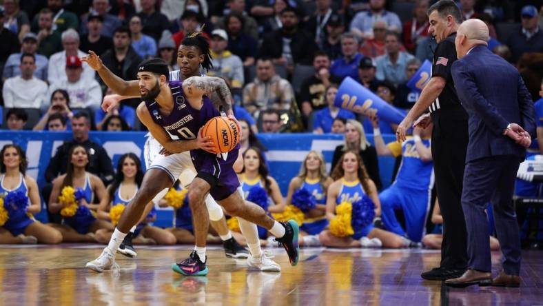 Mar 18, 2023; Sacramento, CA, USA; Northwestern Wildcats guard Boo Buie (0) looks for a pass while defended by UCLA Bruins guard Dylan Andrews (2) during the first half at Golden 1 Center. Mandatory Credit: Kelley L Cox-USA TODAY Sports