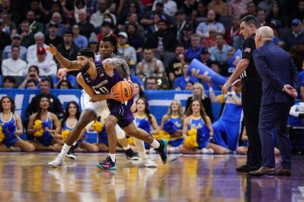 Mar 18, 2023; Sacramento, CA, USA; Northwestern Wildcats guard Boo Buie (0) looks for a pass while defended by UCLA Bruins guard Dylan Andrews (2) during the first half at Golden 1 Center. Mandatory Credit: Kelley L Cox-USA TODAY Sports