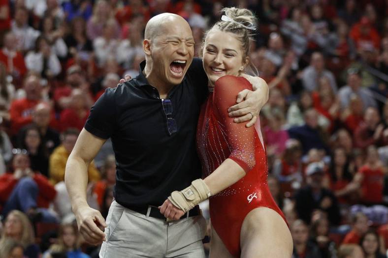 Mar 18, 2023; West Valley City, UT, USA; Utah s head gymnastics coach Tom Farden celebrates with Lucy Stanhope after her vault during the Pac-12 Women's Gymnastics Championship at Maverik Center. Mandatory Credit: Jeffrey Swinger-USA TODAY Sports