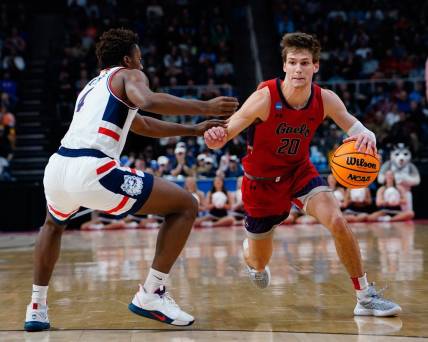 Mar 19, 2023; Albany, NY, USA; Saint Mary's Gaels guard Aidan Mahaney (20) dribbles the ball against Connecticut Huskies guard Nahiem Alleyne (4) during the second half at MVP Arena. Mandatory Credit: Gregory Fisher-USA TODAY Sports