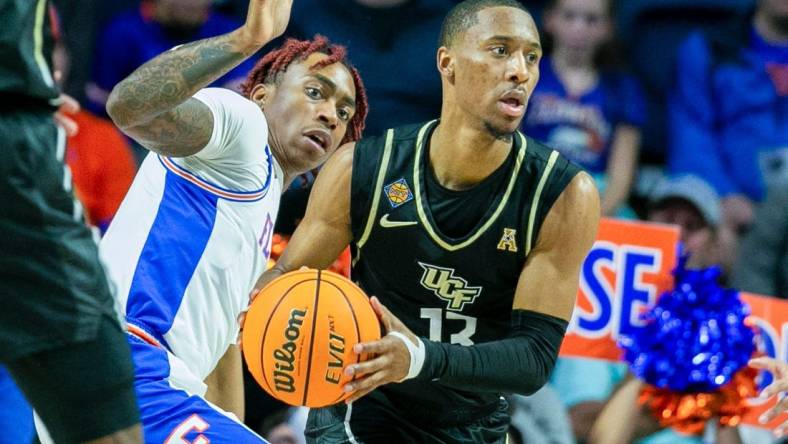 Florida Gators guard Niels Lane (4) tries to get the ball from UCF Knights guard C.J. Kelly (13) during the second half of the NIT tournament Wednesday, March 15, 2023, at Exactech Arena in Gainesville, Fla. Florida lost to UCF 67-49. Alan Youngblood/Gainesville Sun

Gai Ufucf3takeaways2 315753925416