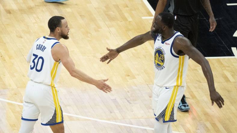 April 30, 2023; Sacramento, California, USA; Golden State Warriors guard Stephen Curry (30) celebrates with forward Draymond Green (23) during the fourth quarter in game seven of the 2023 NBA playoffs first round against the Sacramento Kings at Golden 1 Center. Mandatory Credit: Kyle Terada-USA TODAY Sports