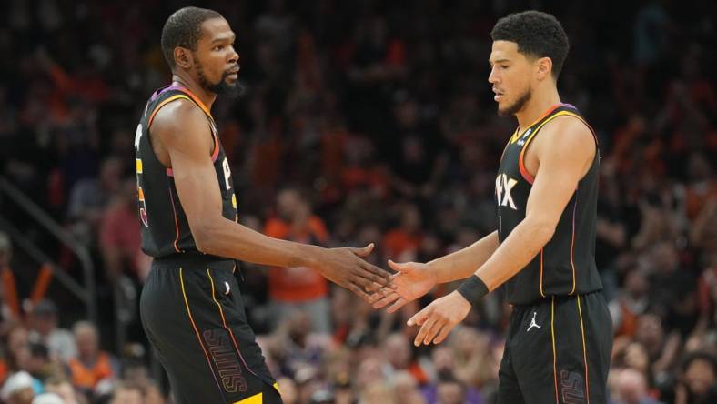 May 11, 2023; Phoenix, Arizona, USA; Phoenix Suns forward Kevin Durant (35) and Phoenix Suns guard Devin Booker (1) slap hands during the first half of game six of the 2023 NBA playoffs against the Denver Nuggets at Footprint Center. Mandatory Credit: Joe Camporeale-USA TODAY Sports