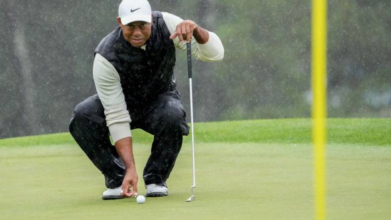 Tiger Woods lines up his putt on the 18th green during the second round of The Masters in April.