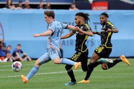 Jun 17, 2023; New York, New York, USA; New York City FC forward Gabriel Segal (19) scores a goal against Columbus Crew SC defenders Mohamed Farsi (23) and Steven Moreira (31) during the second half at Yankee Stadium. Mandatory Credit: Brad Penner-USA TODAY Sports