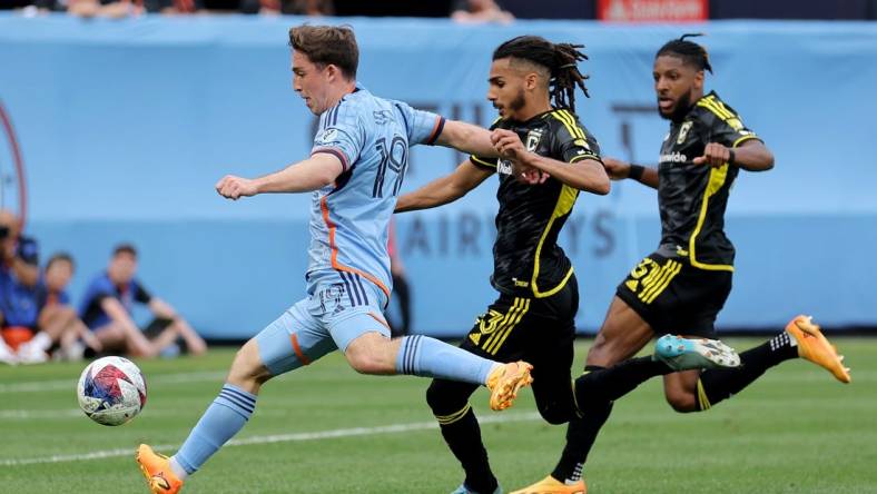 Jun 17, 2023; New York, New York, USA; New York City FC forward Gabriel Segal (19) scores a goal against Columbus Crew SC defenders Mohamed Farsi (23) and Steven Moreira (31) during the second half at Yankee Stadium. Mandatory Credit: Brad Penner-USA TODAY Sports