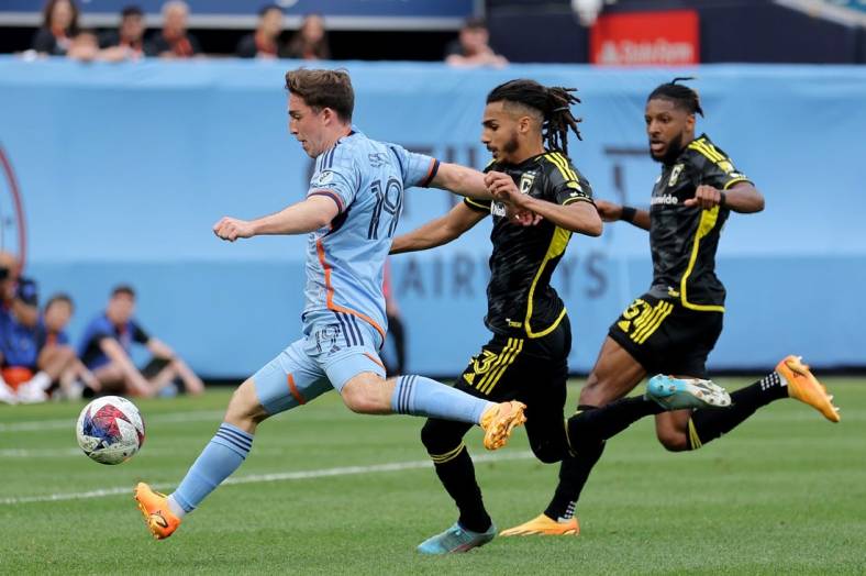 Jun 17, 2023; New York, New York, USA; New York City FC forward Gabriel Segal (19) scores a goal against Columbus Crew SC defenders Mohamed Farsi (23) and Steven Moreira (31) during the second half at Yankee Stadium. Mandatory Credit: Brad Penner-USA TODAY Sports