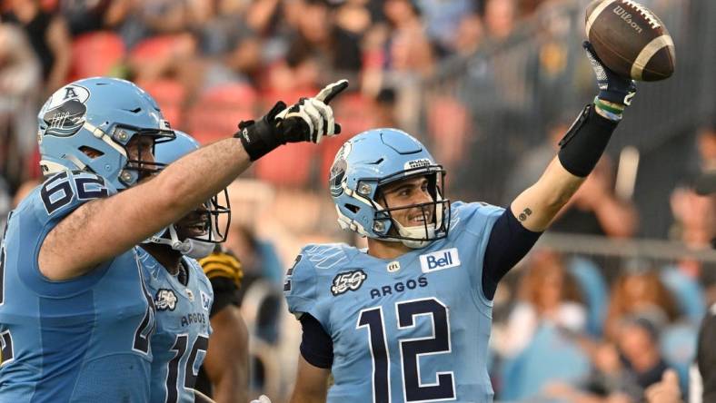 Jun 18, 2023; Toronto, Ontario, CAN;  Toronto Argonauts quarter Chad Kelly (2) celebrates after scoring a touchdown against the Hamilton Tiger-Cats in the second quarter at BMO Field. Mandatory Credit: Dan Hamilton-USA TODAY Sports