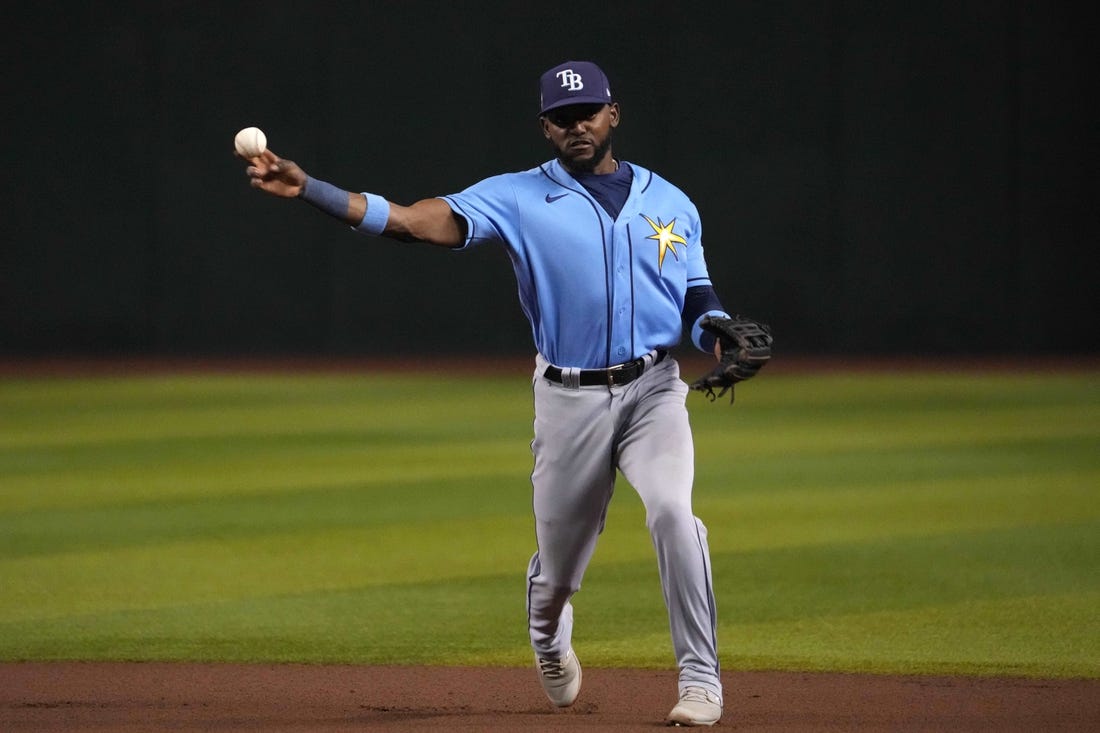 Jun 28, 2023; Phoenix, Arizona, USA; Tampa Bay Rays second baseman Vidal Brujan (7) throws to first base against the Arizona Diamondbacks during the seventh inning at Chase Field. Mandatory Credit: Joe Camporeale-USA TODAY Sports