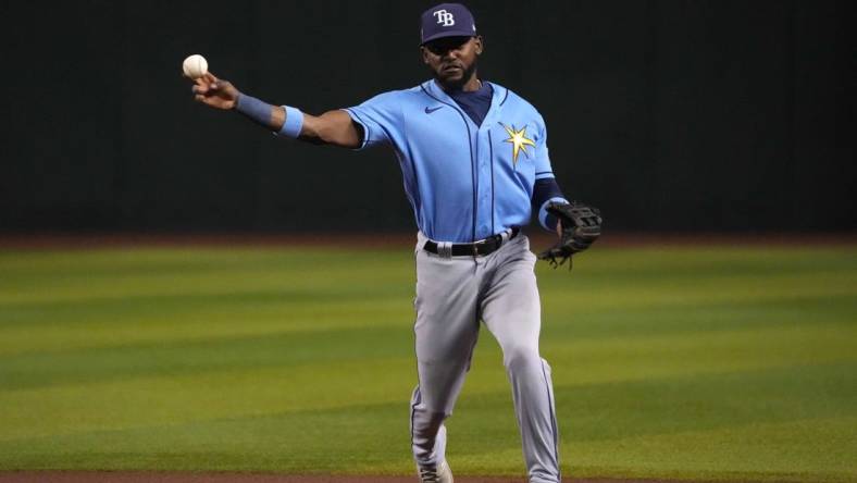 Jun 28, 2023; Phoenix, Arizona, USA; Tampa Bay Rays second baseman Vidal Brujan (7) throws to first base against the Arizona Diamondbacks during the seventh inning at Chase Field. Mandatory Credit: Joe Camporeale-USA TODAY Sports