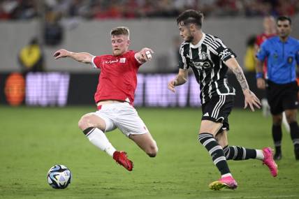 Jul 25, 2023; San Diego, California, USA; Wrexham midfielder Andy Cannon (20) and Manchester United forward Joe Hugill (52) battle for the ball during the second half at Snapdragon Stadium. Mandatory Credit: Orlando Ramirez-USA TODAY Sports