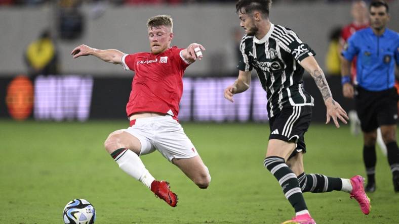 Jul 25, 2023; San Diego, California, USA; Wrexham midfielder Andy Cannon (20) and Manchester United forward Joe Hugill (52) battle for the ball during the second half at Snapdragon Stadium. Mandatory Credit: Orlando Ramirez-USA TODAY Sports