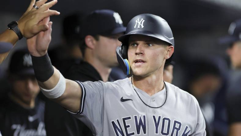 Aug 11, 2023; Miami, Florida, USA; New York Yankees first baseman Jake Bauers (61) celebrates after scoring against the Miami Marlins during the fourth inning at loanDepot Park. Mandatory Credit: Sam Navarro-USA TODAY Sports