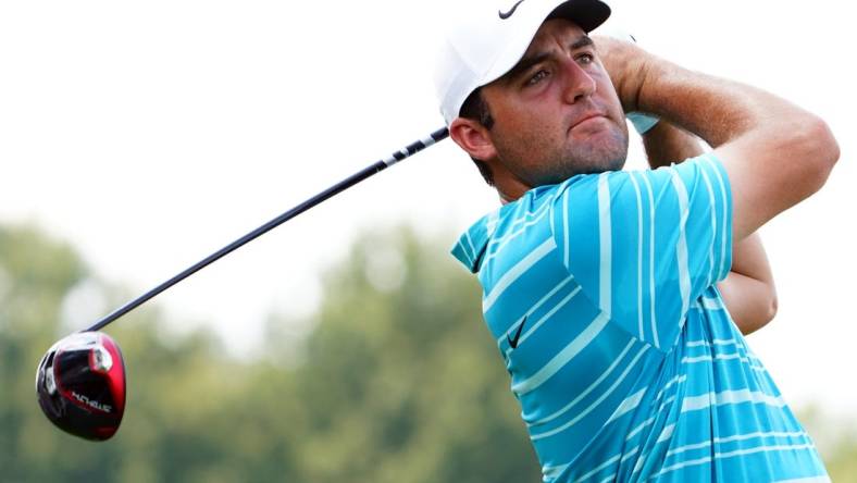 Aug 26, 2023; Atlanta, Georgia, USA; Scottie Scheffler plays his shot from the fourth tee during the third round of the TOUR Championship golf tournament at East Lake Golf Club. Mandatory Credit: John David Mercer-USA TODAY Sports