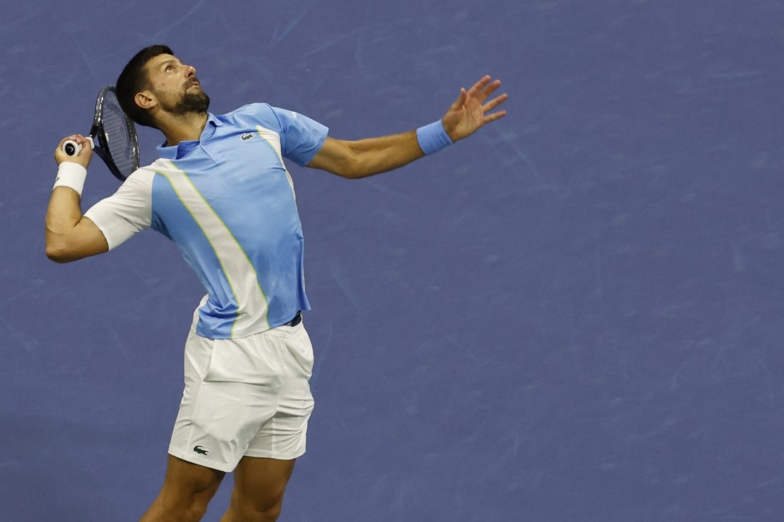 Sep 8, 2023; Flushing, NY, USA; Novak Djokovic of Serbia serves against Ben Shelton of the United States (not pictured) in a men's singles semifinal on day twelve of the 2023 U.S. Open tennis tournament at USTA Billie Jean King Tennis Center. Mandatory Credit: Geoff Burke-USA TODAY Sports