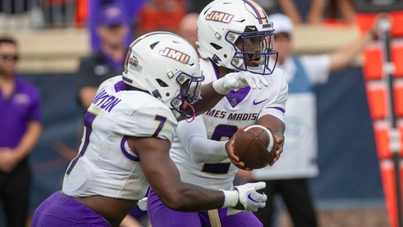 Sept 9, 2023; Charlottesville, Virginia, USA; James Madison Dukes quarterback Jordan McCloud (2) passes off the ball to James Madison Dukes running back Ty Son Lawton (7) to run a play during the second half at Scott Stadium. Mandatory Credit: Hannah Pajewski-USA TODAY Sports