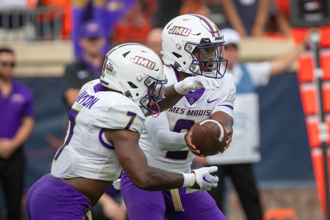 Sept 9, 2023; Charlottesville, Virginia, USA; James Madison Dukes quarterback Jordan McCloud (2) passes off the ball to James Madison Dukes running back Ty Son Lawton (7) to run a play during the second half at Scott Stadium. Mandatory Credit: Hannah Pajewski-USA TODAY Sports