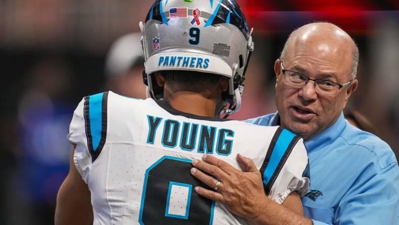 Sep 10, 2023; Atlanta, Georgia, USA; Carolina Panthers quarterback Bryce Young (9) hugs team owner David Tepper on the field prior to the game against the Atlanta Falcons at Mercedes-Benz Stadium. Mandatory Credit: Dale Zanine-USA TODAY Sports