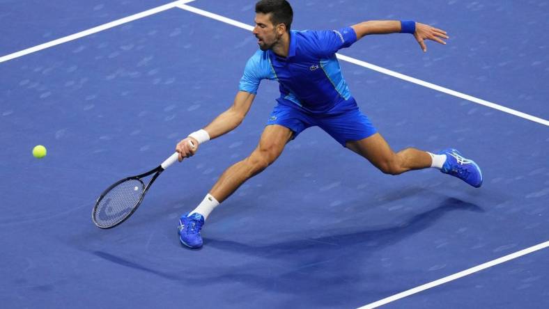 Sep 10, 2023; Flushing, NY, USA; Novak Djokovic of Serbia reaches for a forehand against Daniil Medvedev (not pictured) in the men's singles final in the men's singles final on day fourteen of the 2023 U.S. Open tennis tournament at USTA Billie Jean King National Tennis Center. Mandatory Credit: Danielle Parhizkaran-USA TODAY Sports