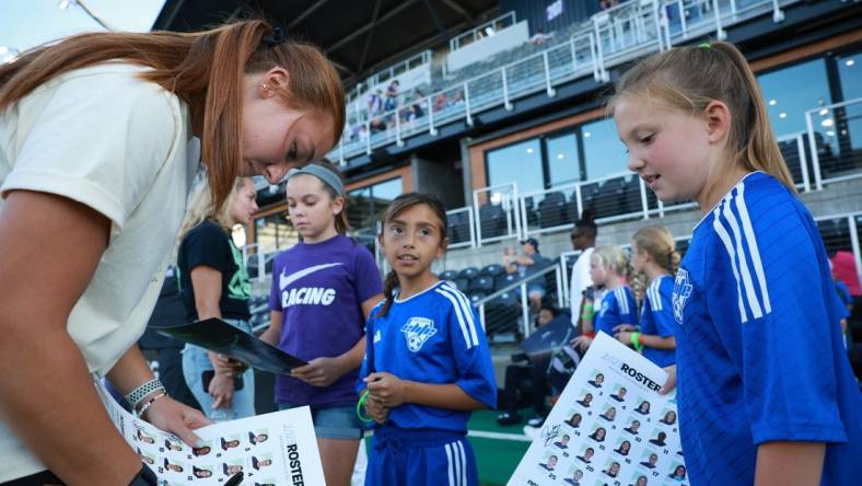 Sep 15, 2023; Louisville, Kentucky, USA; Racing Louisville FC goalkeeper Jordyn Bloomer (24) signs autographs before the match against the Houston Dash at Lynn Family Stadium. Mandatory Credit: EM Dash-USA TODAY Sports