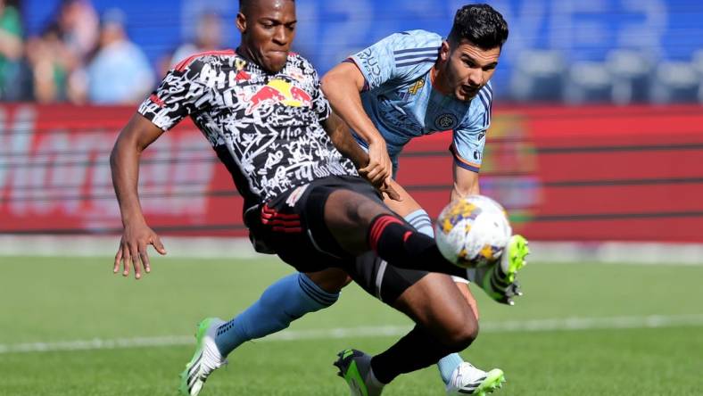 Sep 16, 2023; New York, New York, USA; New York Red Bulls defender Hassan Ndam (98) plays the ball against New York City FC forward Mounsef Bakrar (9) during the first half at Yankee Stadium. Mandatory Credit: Brad Penner-USA TODAY Sports