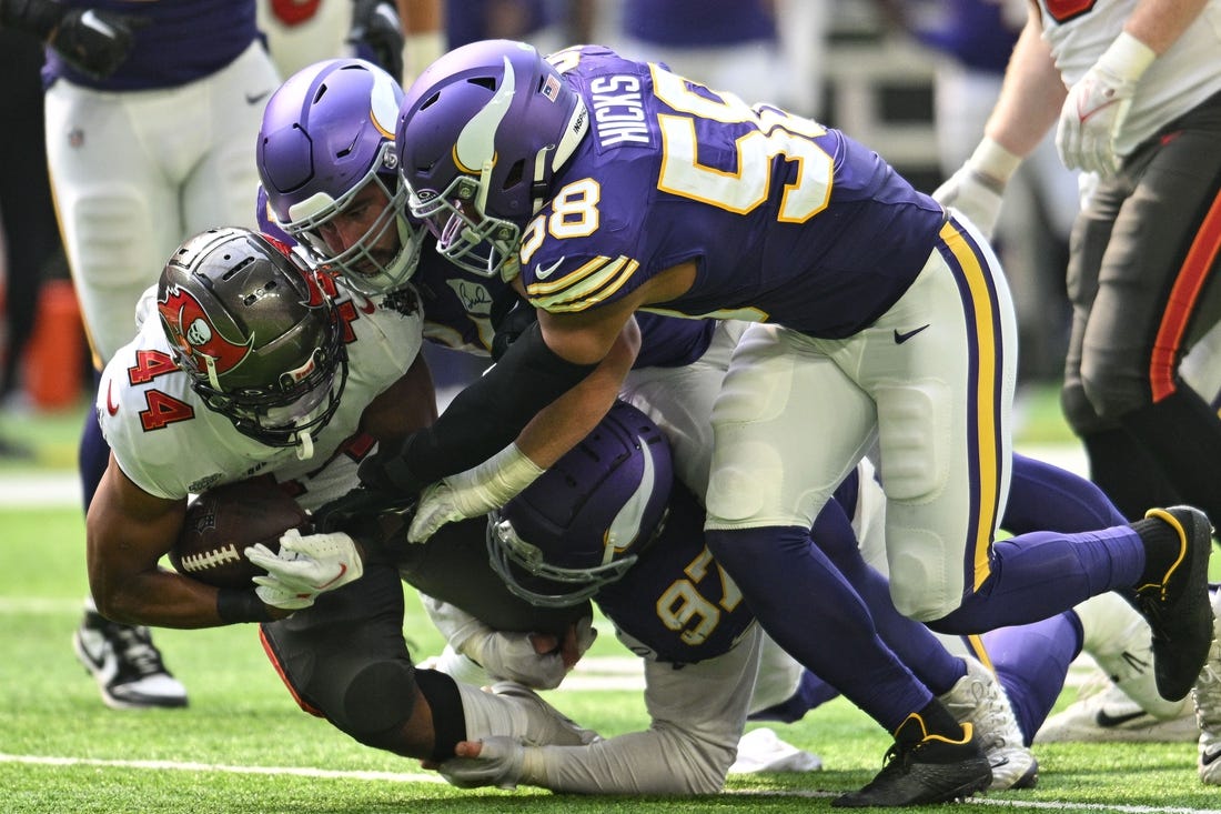 Sep 10, 2023; Minneapolis, Minnesota, USA; Tampa Bay Buccaneers running back Sean Tucker (44) runs the ball as Minnesota Vikings linebacker Jordan Hicks (58) and defensive tackle Harrison Phillips (97) make the tackle during the game at U.S. Bank Stadium. Mandatory Credit: Jeffrey Becker-USA TODAY Sports