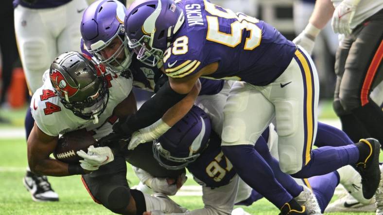 Sep 10, 2023; Minneapolis, Minnesota, USA; Tampa Bay Buccaneers running back Sean Tucker (44) runs the ball as Minnesota Vikings linebacker Jordan Hicks (58) and defensive tackle Harrison Phillips (97) make the tackle during the game at U.S. Bank Stadium. Mandatory Credit: Jeffrey Becker-USA TODAY Sports