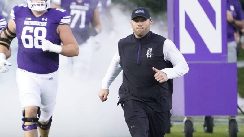 Sep 23, 2023; Evanston, Illinois, USA; Northwestern Wildcats head coach David Braun leads his team on the field before the game against the Minnesota Golden Gophers at Ryan Field. Mandatory Credit: David Banks-USA TODAY Sports