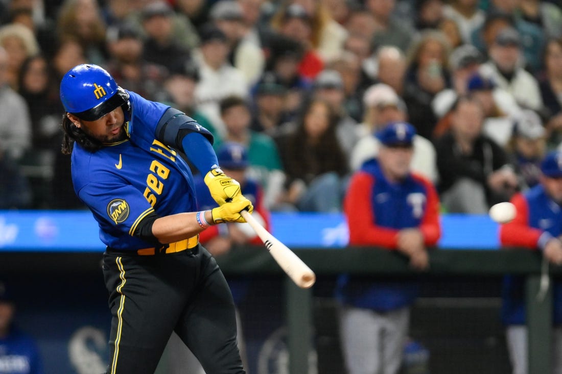 Sep 29, 2023; Seattle, Washington, USA; Seattle Mariners third baseman Eugenio Suarez (28) hits an RBI double against the Texas Rangers during the third inning at T-Mobile Park. Mandatory Credit: Steven Bisig-USA TODAY Sports