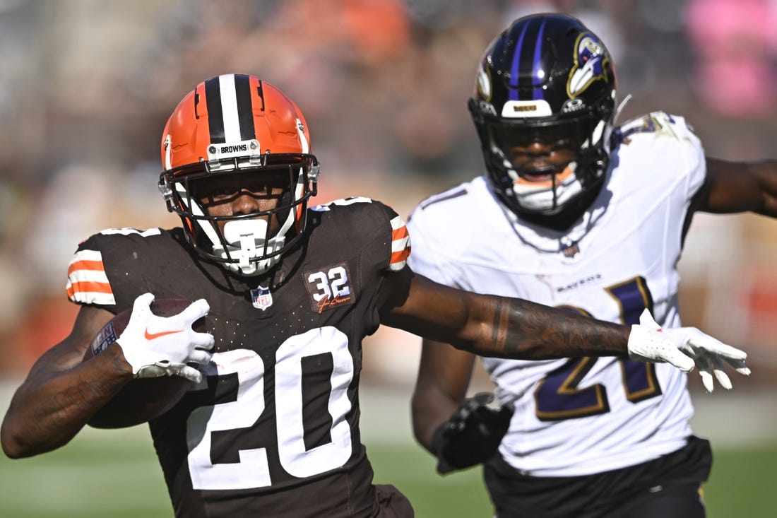 Oct 1, 2023; Cleveland, Ohio, USA; Cleveland Browns running back Pierre Strong Jr. (20) runs with the ball beside Baltimore Ravens cornerback Brandon Stephens (21) in the fourth quarter at Cleveland Browns Stadium. Mandatory Credit: David Richard-USA TODAY Sports