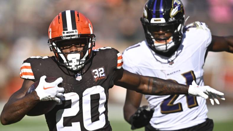 Oct 1, 2023; Cleveland, Ohio, USA; Cleveland Browns running back Pierre Strong Jr. (20) runs with the ball beside Baltimore Ravens cornerback Brandon Stephens (21) in the fourth quarter at Cleveland Browns Stadium. Mandatory Credit: David Richard-USA TODAY Sports