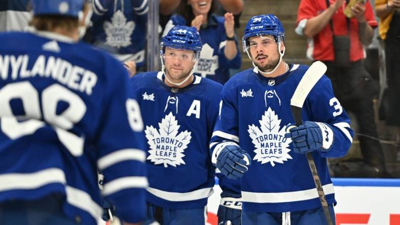 Oct 5, 2023; Toronto, Ontario, CAN; Toronto Maple Leafs forward Auston Matthews (34) celebrates with defenseman Morgan Rielly (44) and forward William Nylander (88) after scoring a goal against the Detroit Red Wings in the first period at Scotiabank Arena. Mandatory Credit: Dan Hamilton-USA TODAY Sports