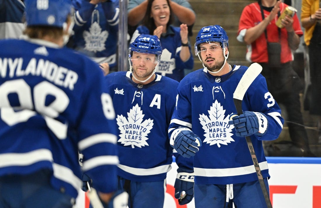 Oct 5, 2023; Toronto, Ontario, CAN; Toronto Maple Leafs forward Auston Matthews (34) celebrates with defenseman Morgan Rielly (44) and forward William Nylander (88) after scoring a goal against the Detroit Red Wings in the first period at Scotiabank Arena. Mandatory Credit: Dan Hamilton-USA TODAY Sports
