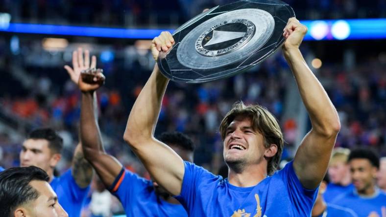 Oct 4, 2023; Cincinnati, Ohio, USA;  FC Cincinnati defender Nick Hagglund celebrates with the Supporters    Shield at TQL Stadium. Mandatory Credit: Aaron Doster-USA TODAY Sports