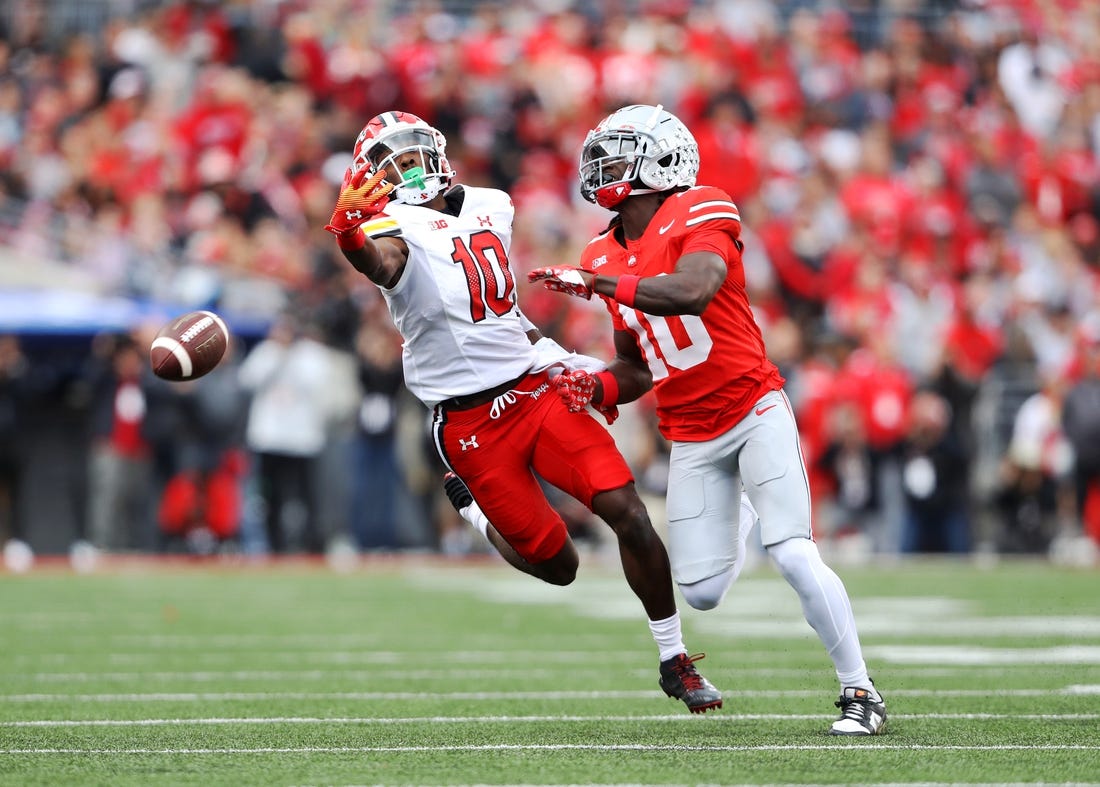 Oct 7, 2023; Columbus, Ohio, USA;  Maryland Terrapins wide receiver Tai Felton (10) attempts to one hand catch the football as Ohio State Buckeyes cornerback Denzel Burke (10) defends during the first quarter at Ohio Stadium. Mandatory Credit: Joseph Maiorana-USA TODAY Sports