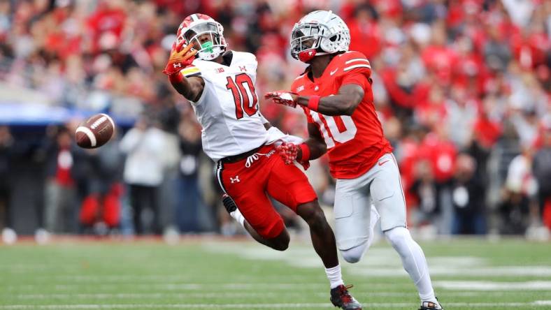 Oct 7, 2023; Columbus, Ohio, USA;  Maryland Terrapins wide receiver Tai Felton (10) attempts to one hand catch the football as Ohio State Buckeyes cornerback Denzel Burke (10) defends during the first quarter at Ohio Stadium. Mandatory Credit: Joseph Maiorana-USA TODAY Sports