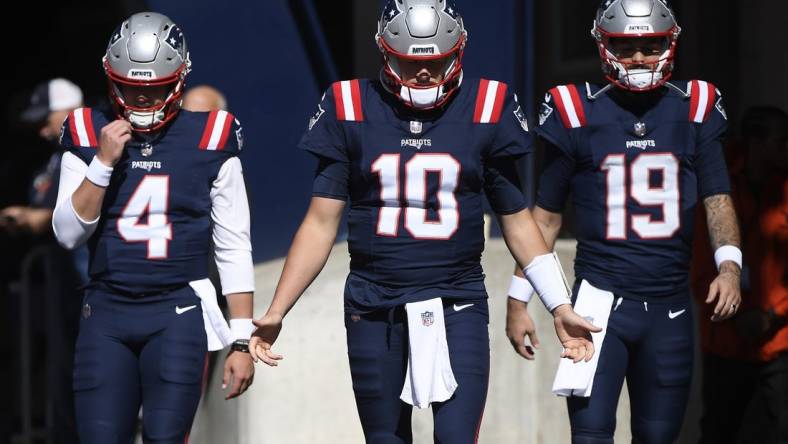 Oct 8, 2023; Foxborough, Massachusetts, USA; New England Patriots quarterback Bailey Zappe (4) quarterback Mac Jones (10) and quarterback Will Grier (19) walk out of the tunnel prior to a game against the New Orleans Saints at Gillette Stadium. Mandatory Credit: Bob DeChiara-USA TODAY Sports